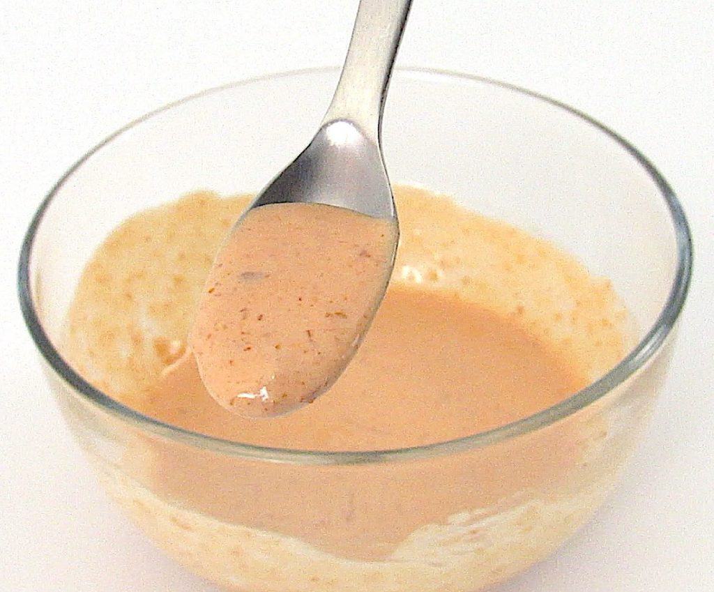bang bang sauce in glass bowl with spoonful