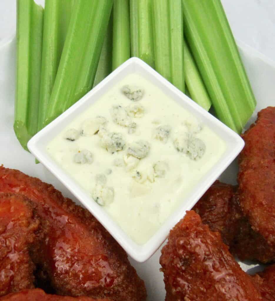 closeup of blue cheese dressing with celery in background