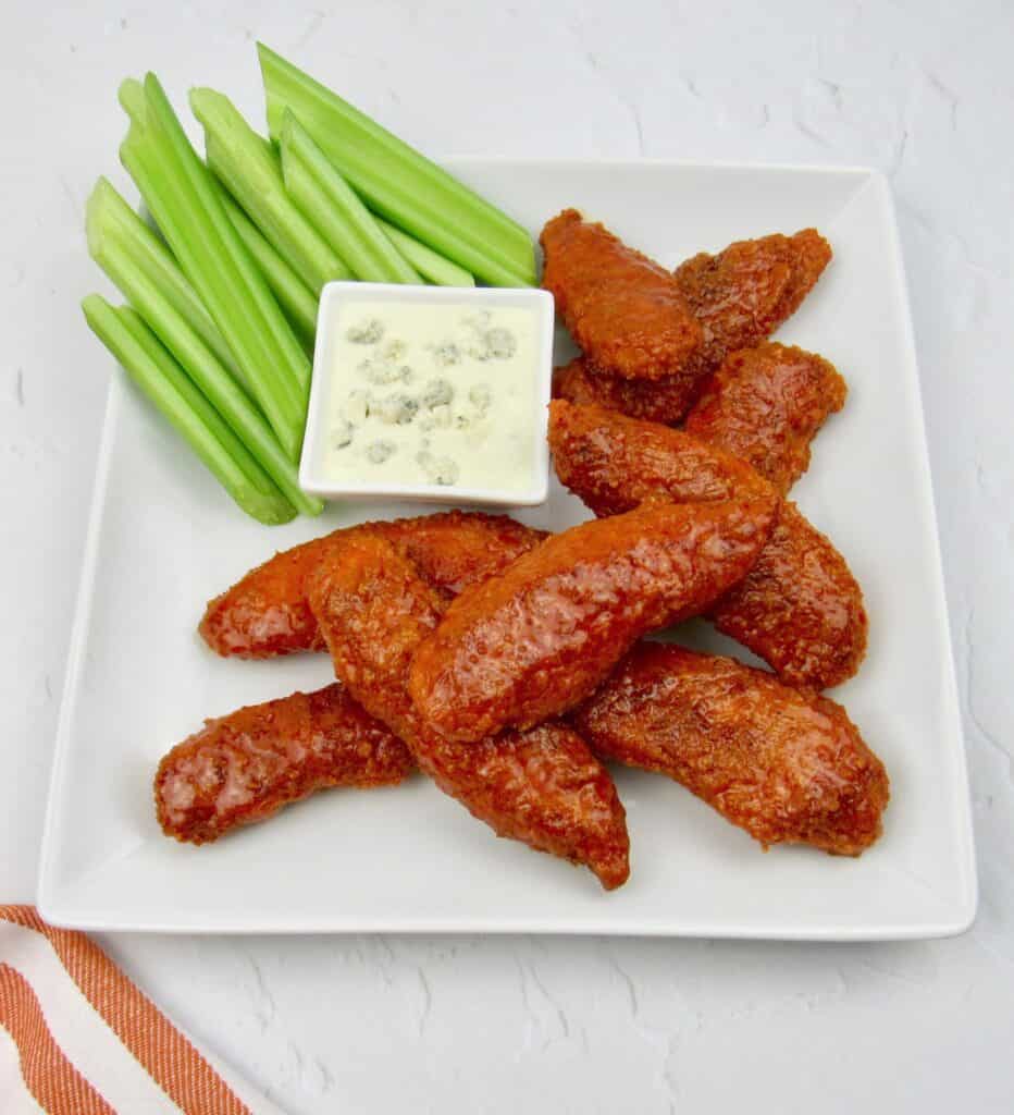 buffalo chicken tenders on plate with celery and blue cheese