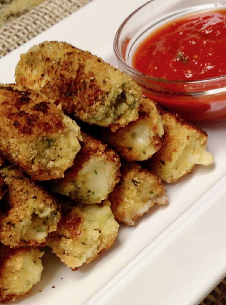 Close Up of Keto/Low Carb/Gluten Free Mozarella Sticks on Serving Plate with Red Sauce