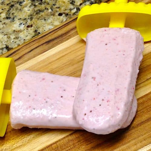 strawberry coconut popsicles on cutting board