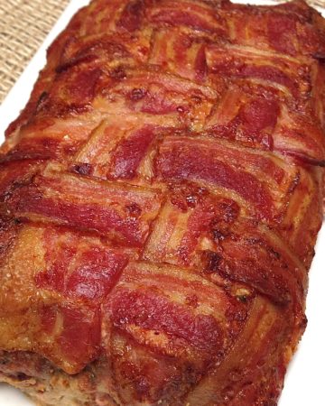 bacon wrapped meatloaf on white plate