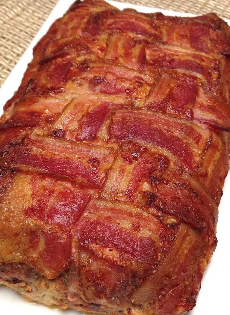 bacon wrapped meatloaf on white plate