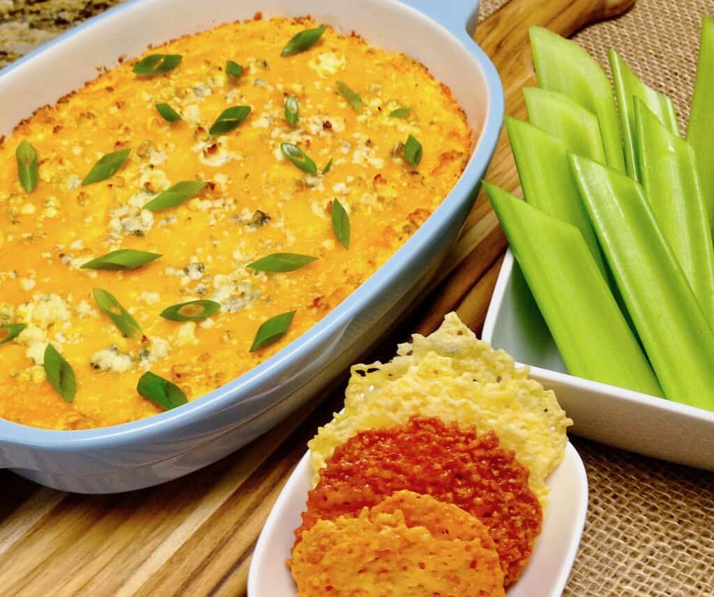overhead view of baked chicken dip with crackers and celery on side
