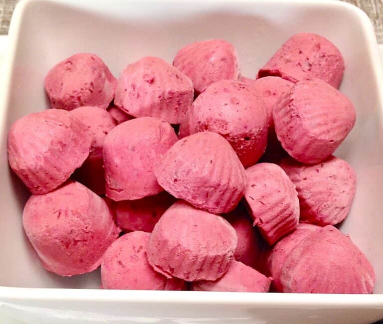 closeup of blackberry fat bombs in white square bowl