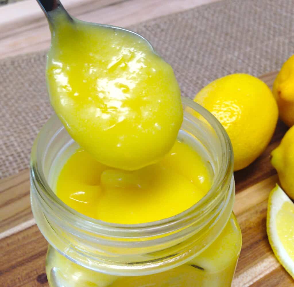 closeup of lemon curd spooned out of a jar