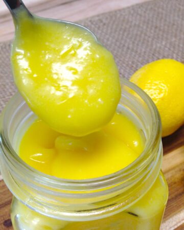 closeup of lemon curd spooned out of a jar