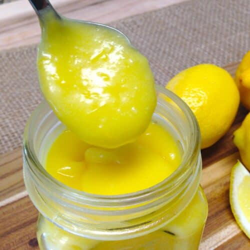 closeup of lemon curd spooned out of a jar
