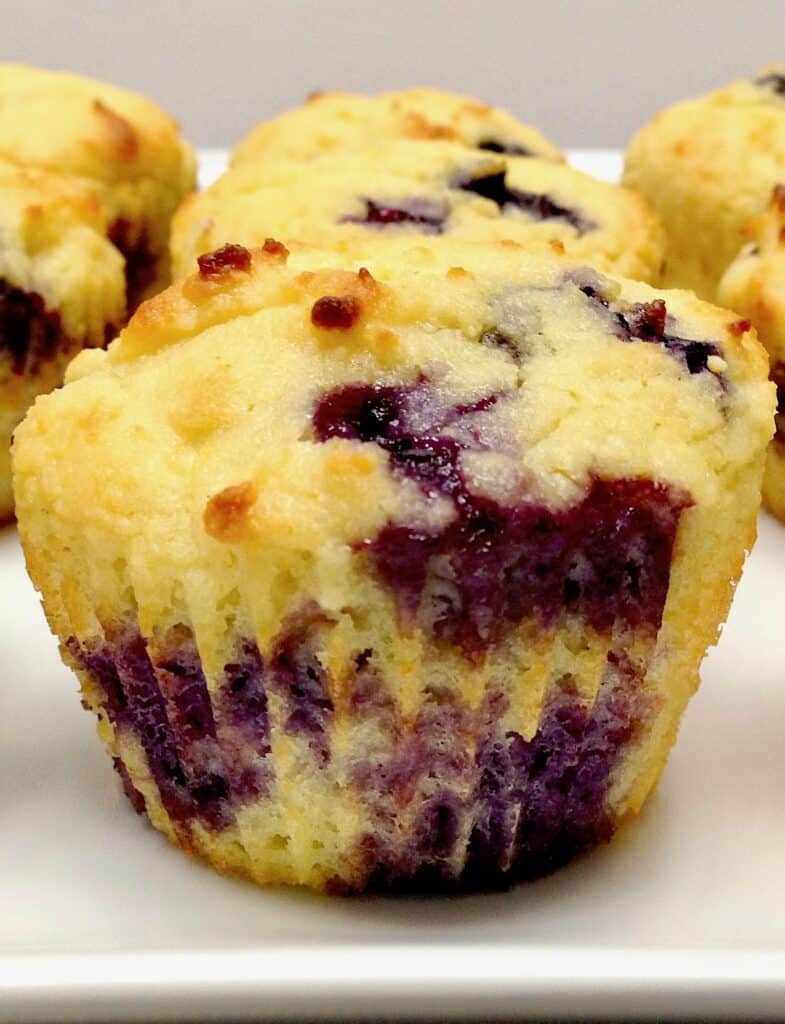 closeup of a blueberry muffin on white platter