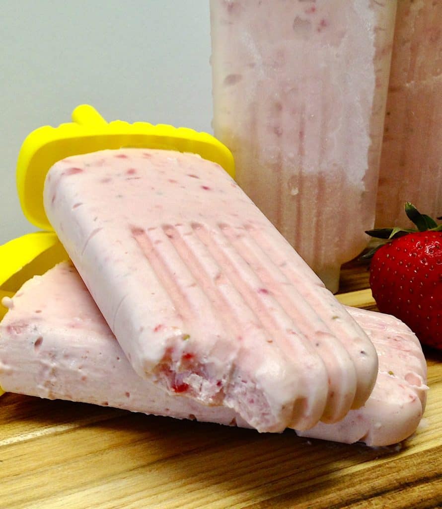 Keto Strawberry Cheesecake Popsicles with a bite taken out