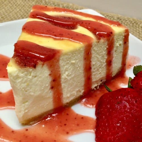 slice of cheesecake with strawberry sauce over the top