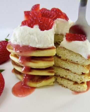 stack of pancakes cut with fork holding some