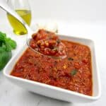 bowl with Italian meat sauce with spoon holding up some