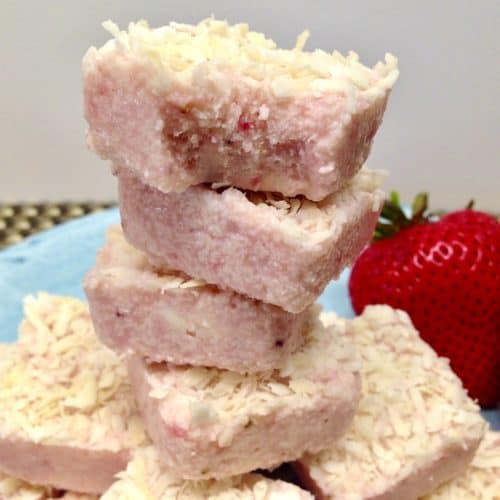 Strawberry Coconut Fat Bombs stacked up on blue plate