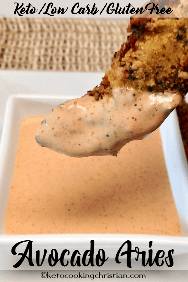Avocado Fry dipped in zesty sauce held over the sauce cup