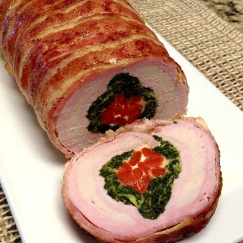 Bacon Wrapped Pork Loin cut open on white plate