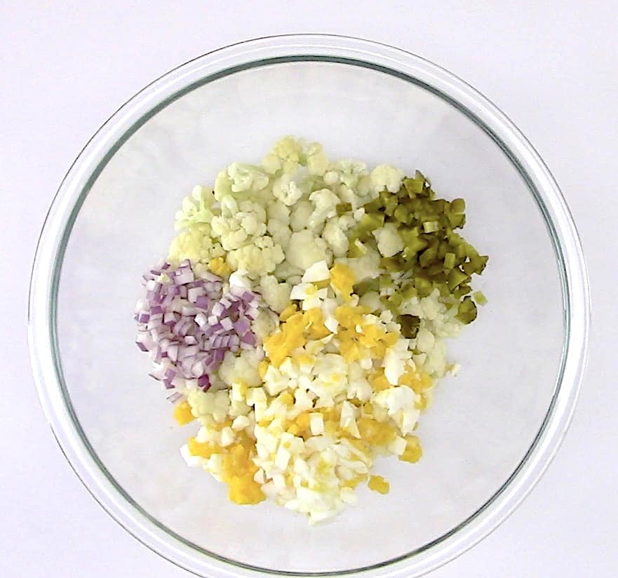 Cauliflower "Potato" Salad ingredients in glass bowl