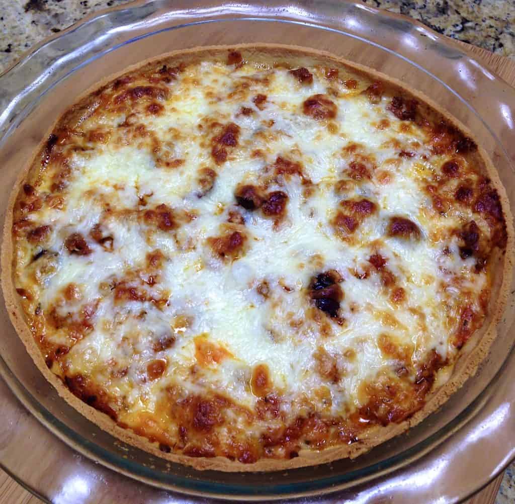 Keto Sausage and Pepperoni Pizza Pie in glass pie dish