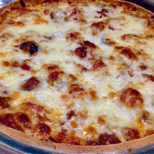 closeup of Keto Sausage and Pepperoni Pizza Pie in glass pie dish