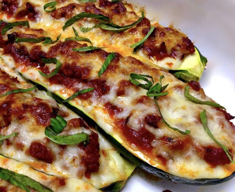 Closeup of Lasagna Stuffed Zucchini Boats with basil on top
