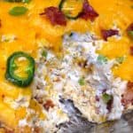 jalapeno popper chicken dip with scoop taken out