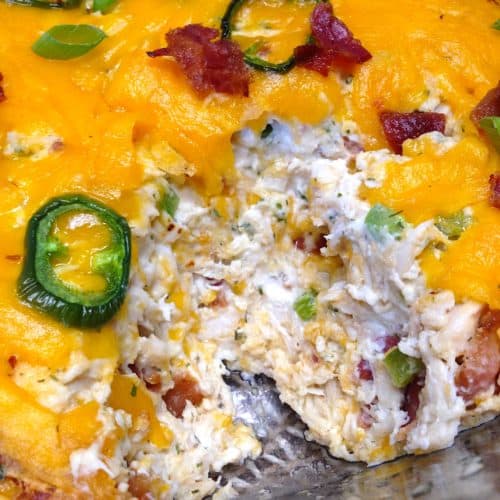 jalapeno popper chicken dip with scoop taken out