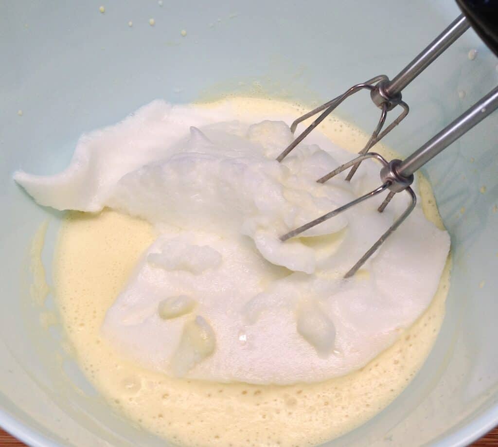 wet ingredients for pancakes and egg whites being mixed
