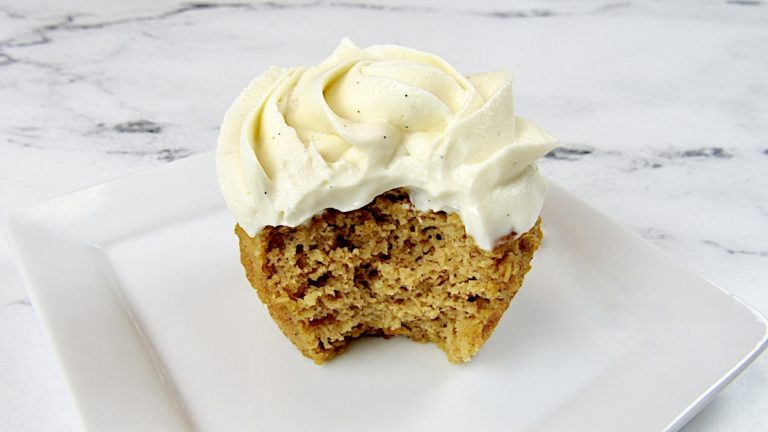 Pumpkin Cupcake with vanilla icing and bite missing