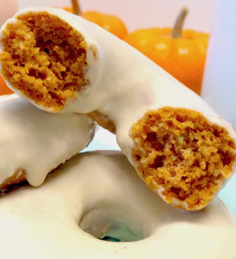 pumpkin donuts with one cut in half on top