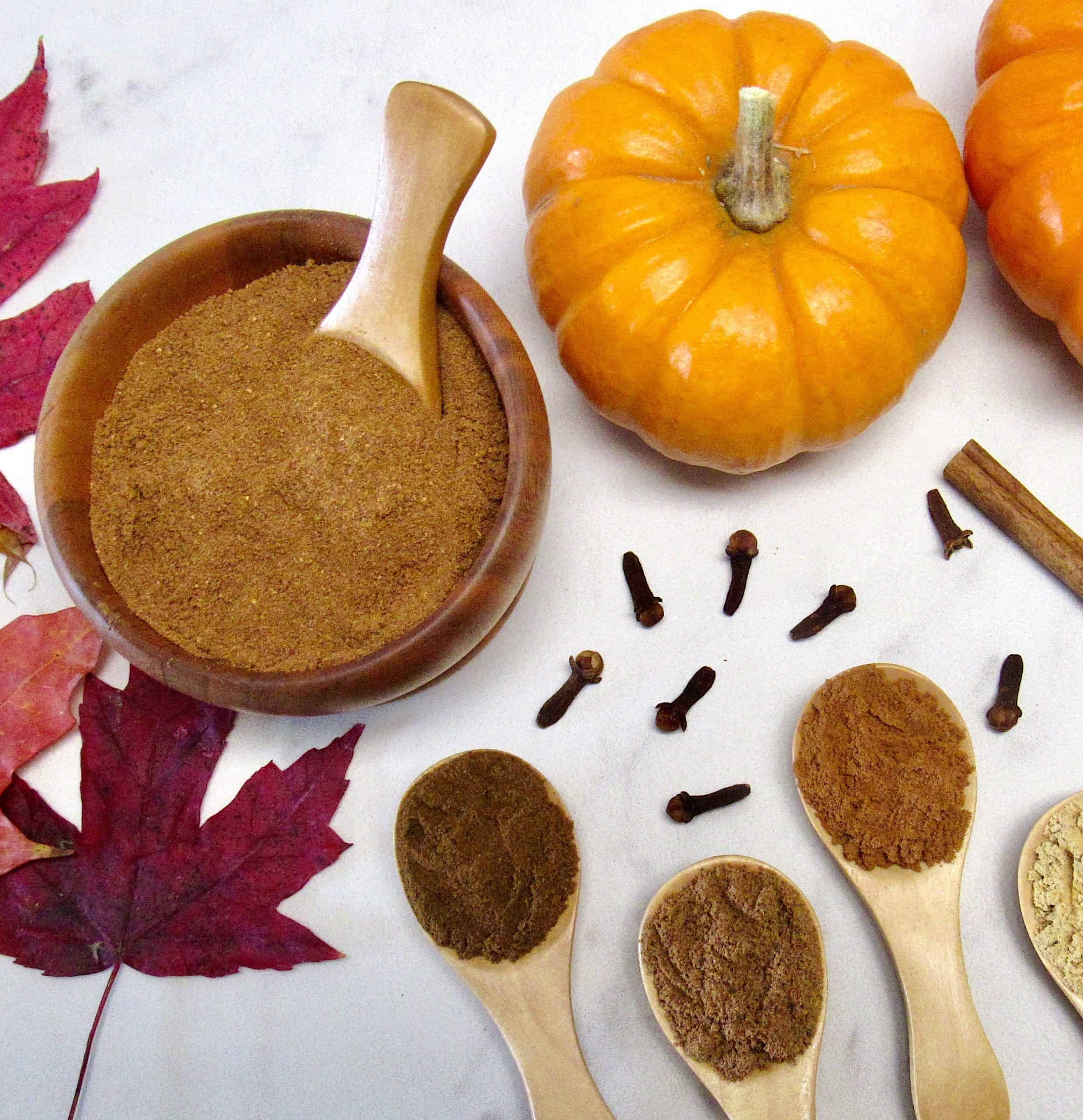 Pumpkin Pie Spice in wooden bowl with pumpkin in background