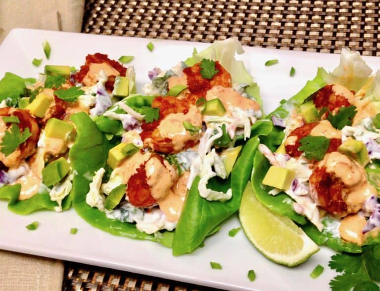 closeup of shrimp in lettuce wraps with bang bang sauce on top