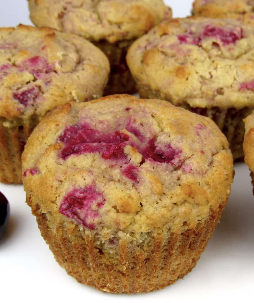closeup of cranberry walnut muffin on white plate