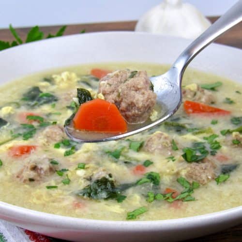 Keto Italian Wedding Soup with spoon holding up some