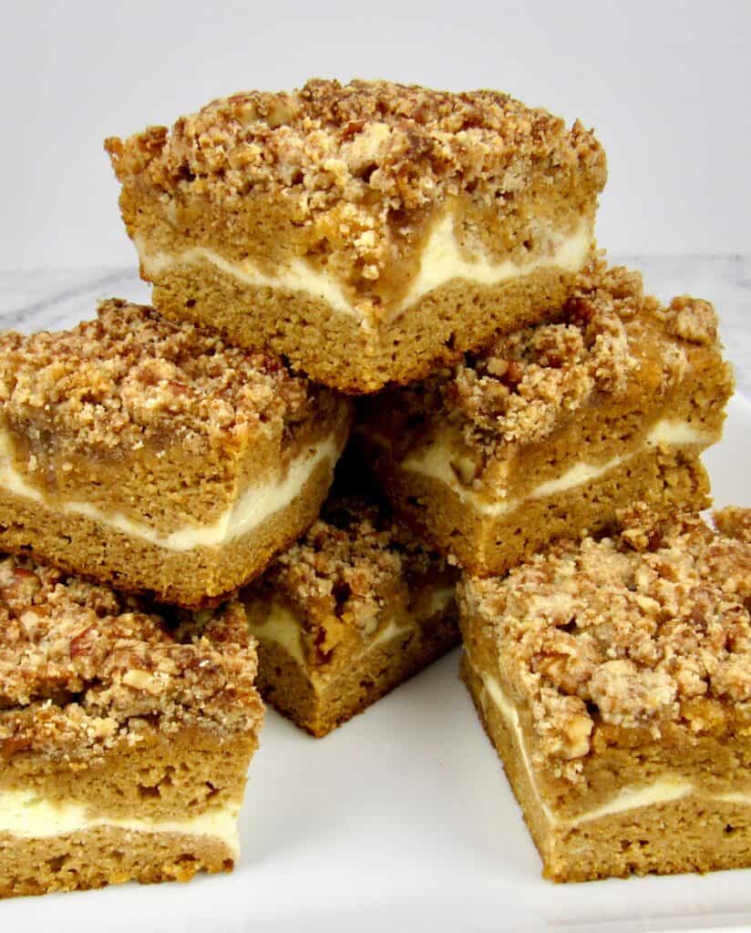 slices of pumpkin coffee cake stacked up on a square plate