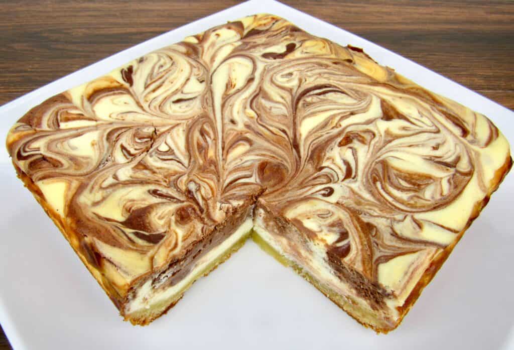 vanilla and chocolate swirl cheesecake with slice taken out