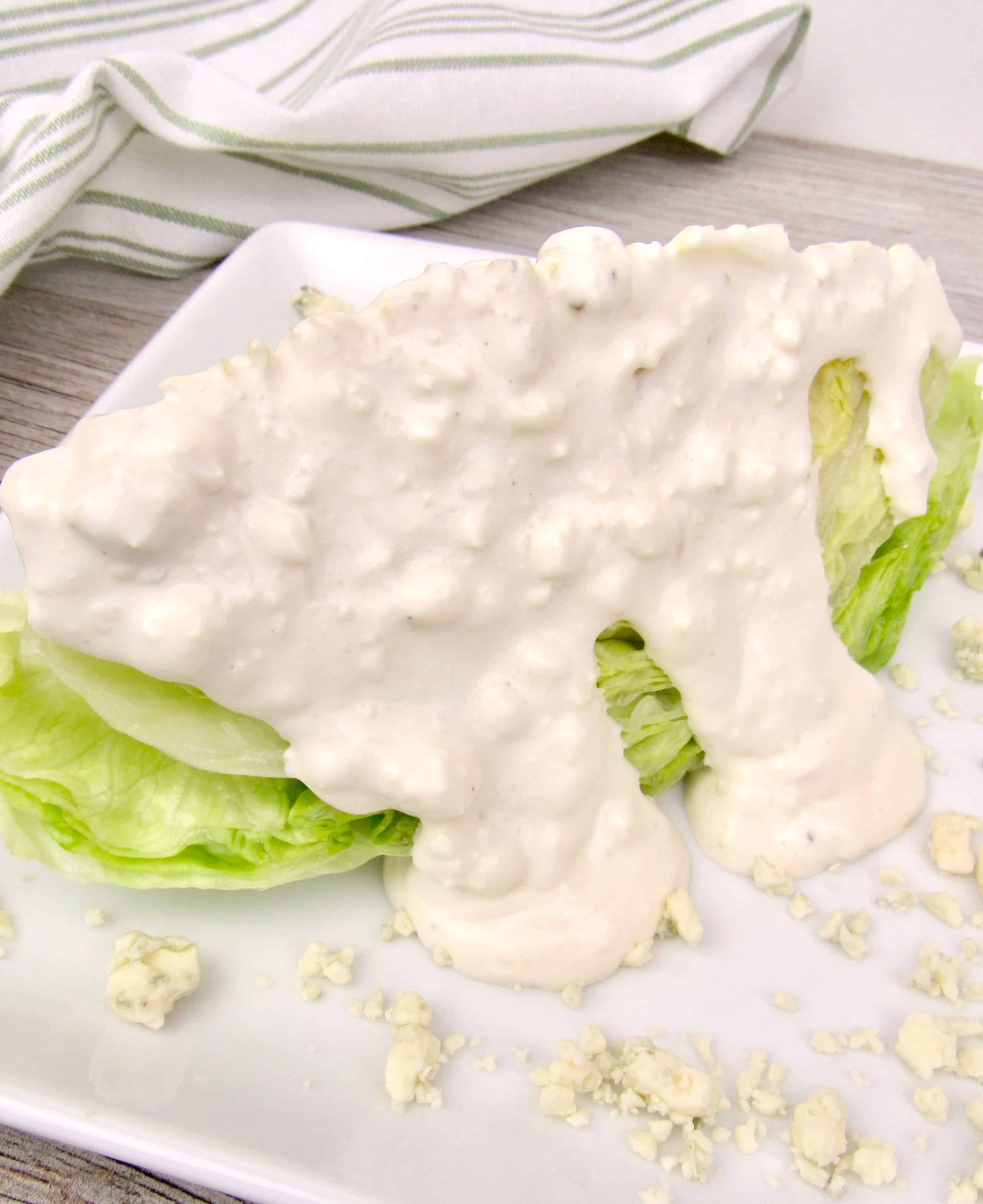 wedge of iceberg lettuce topped with blue cheese dressing