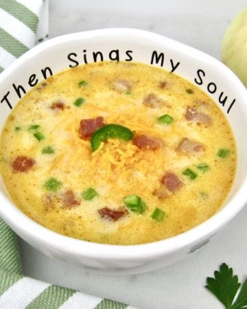 closeup of bowl of jalapeno popper soup with cheese on top