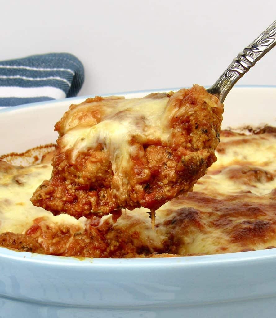 Keto Chicken Parmesan Casserole being spooned out