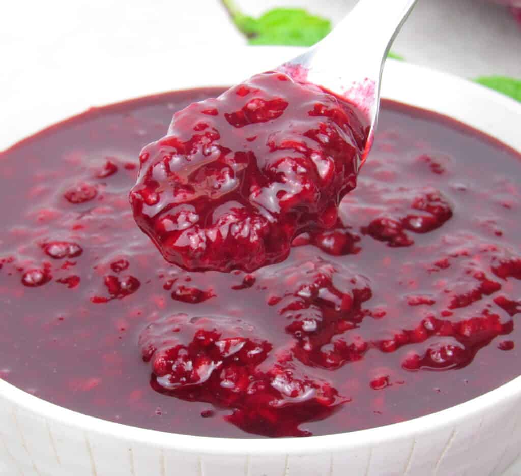 raspberry sauce in bowl being spooned out