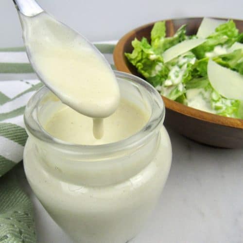 keto caesar dressing in glass jar with spoonful