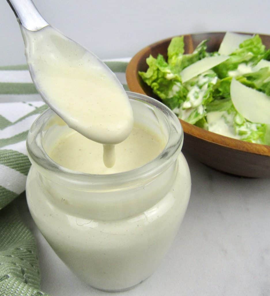 keto caesar dressing in glass jar with spoonful