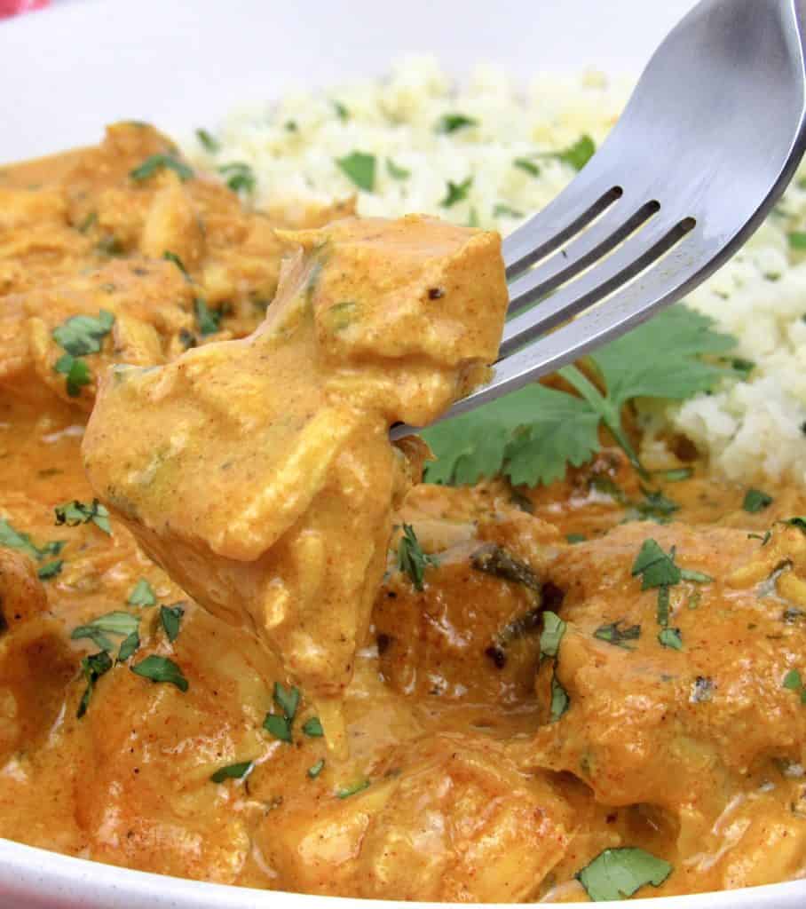 butter chicken with fork holding up some