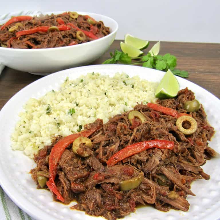 ropa vieja with cauliflower rice on white plate