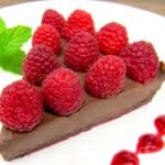 slice of chocolate tart with raspberries on top