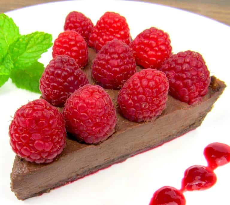 slice of chocolate tart with raspberries on top