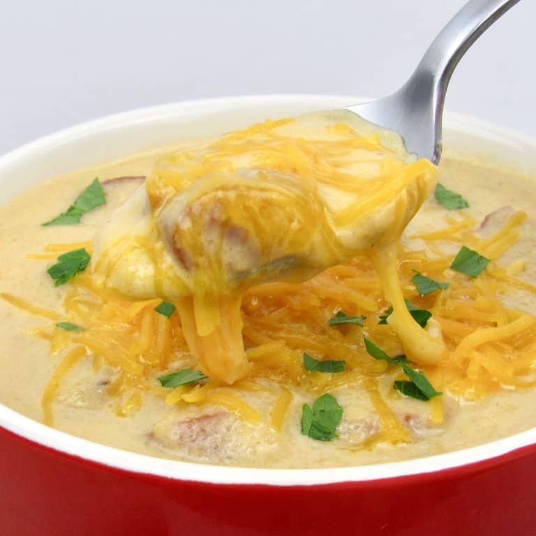 Smoked Sausage and Cauliflower Soup with spoon holding up some
