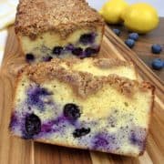 Blueberry Crumb Loaf on cutting board with lemons in background
