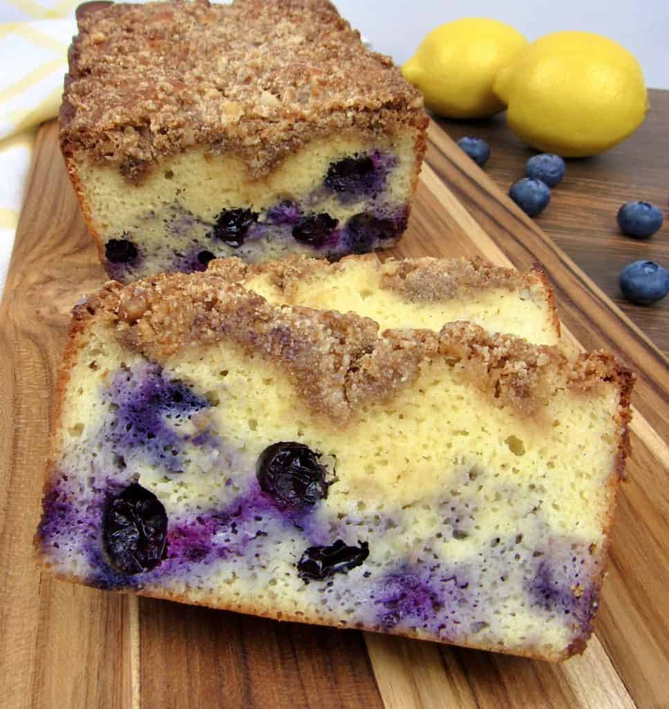 Blueberry Crumb Loaf on cutting board with lemons in background