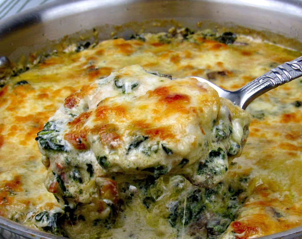 chicken florentine in skillet with spoonful
