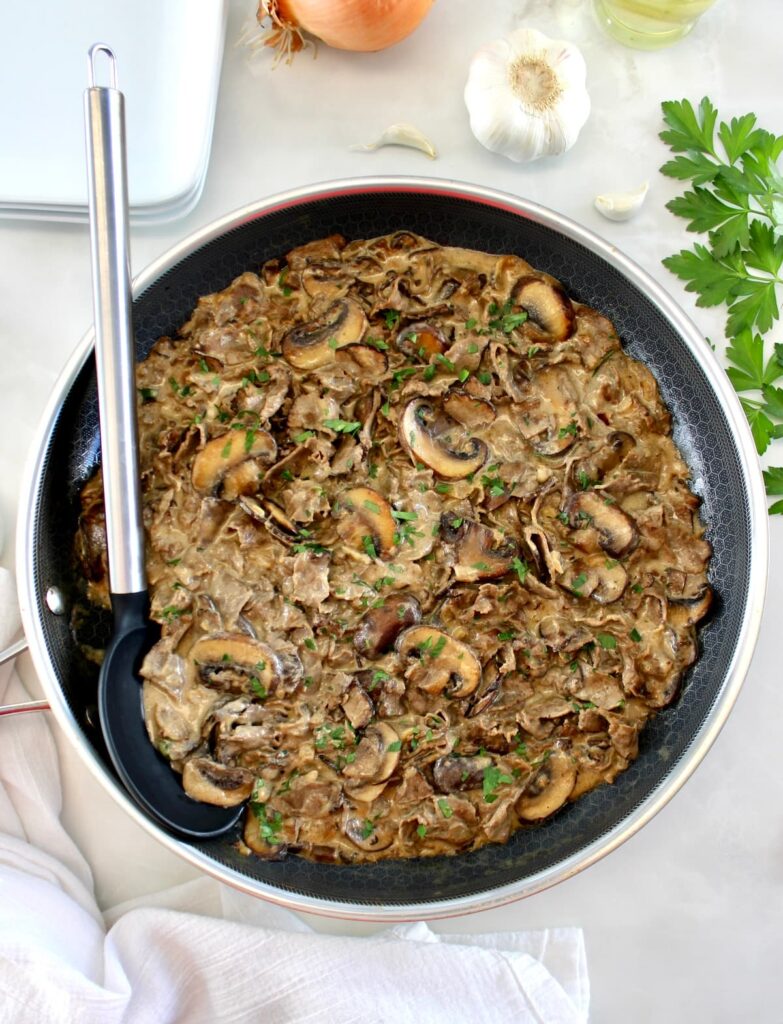 Easy Beef Stroganoff in skillet with serving spoon on side